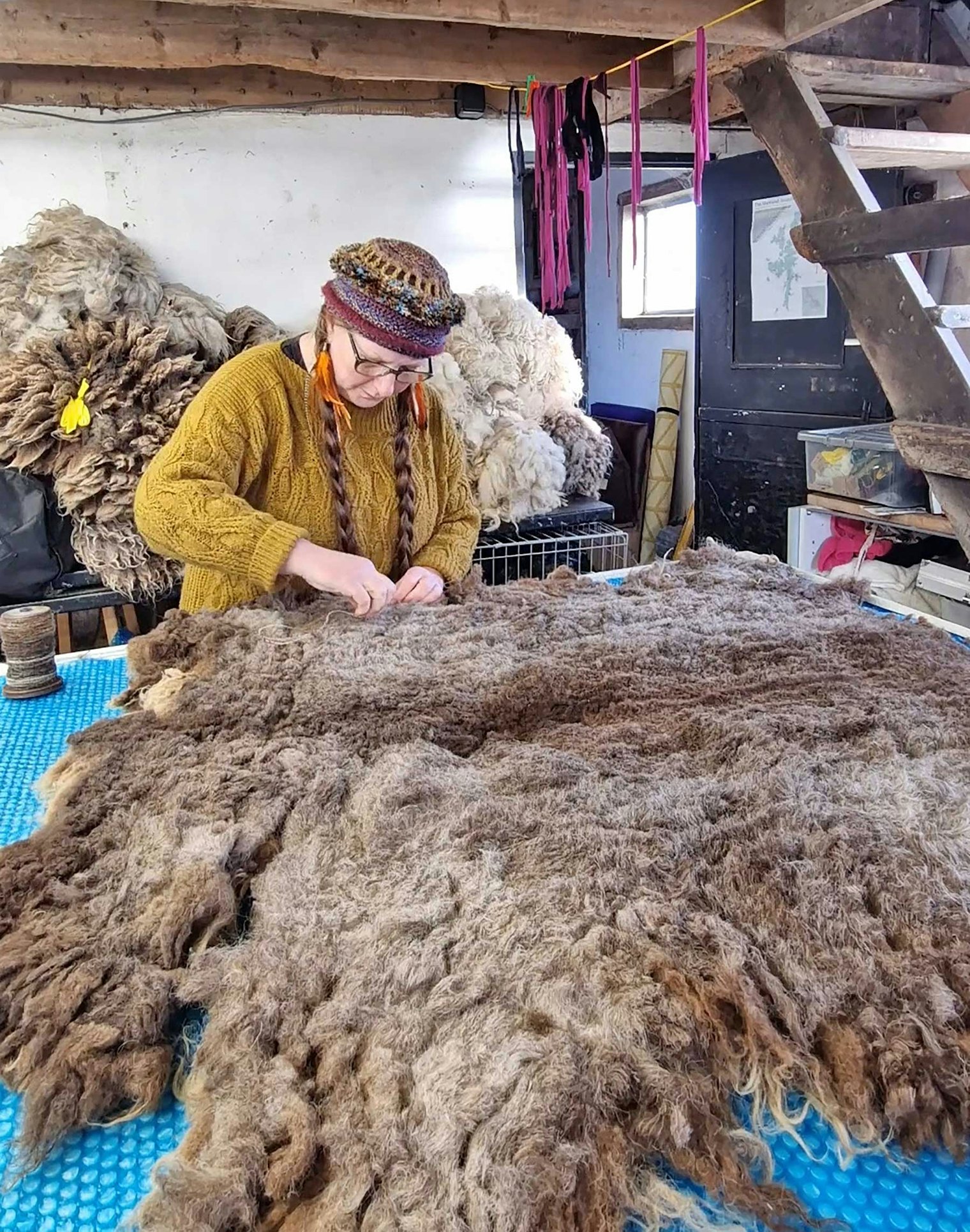 Helen is felting the back of the fleece by hand, which holds the fleece together, making each rug cruelty free.