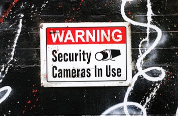 security cameras in use warning sign