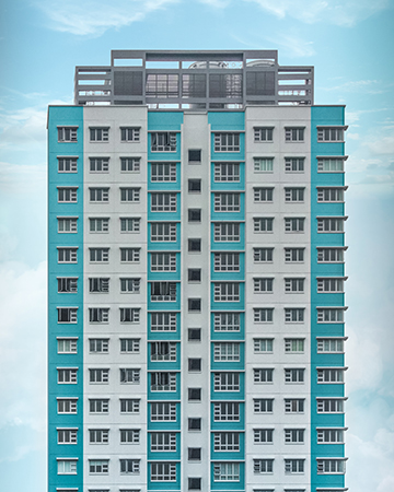 a skyscraper of apartments with a blue sky in the background.
