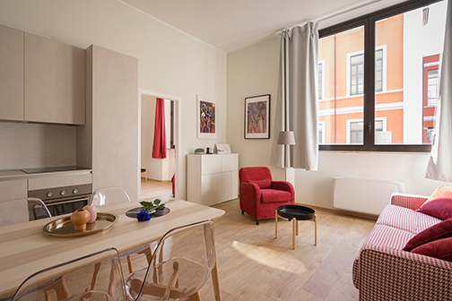 an apartment with lots of wood and red decorations. Perfect for a Cove apartment security system.