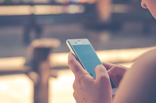 A woman holding a smartphone