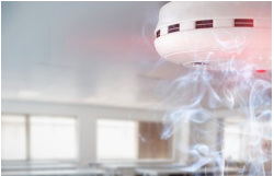 Smoke rising and entering a smoke detector.