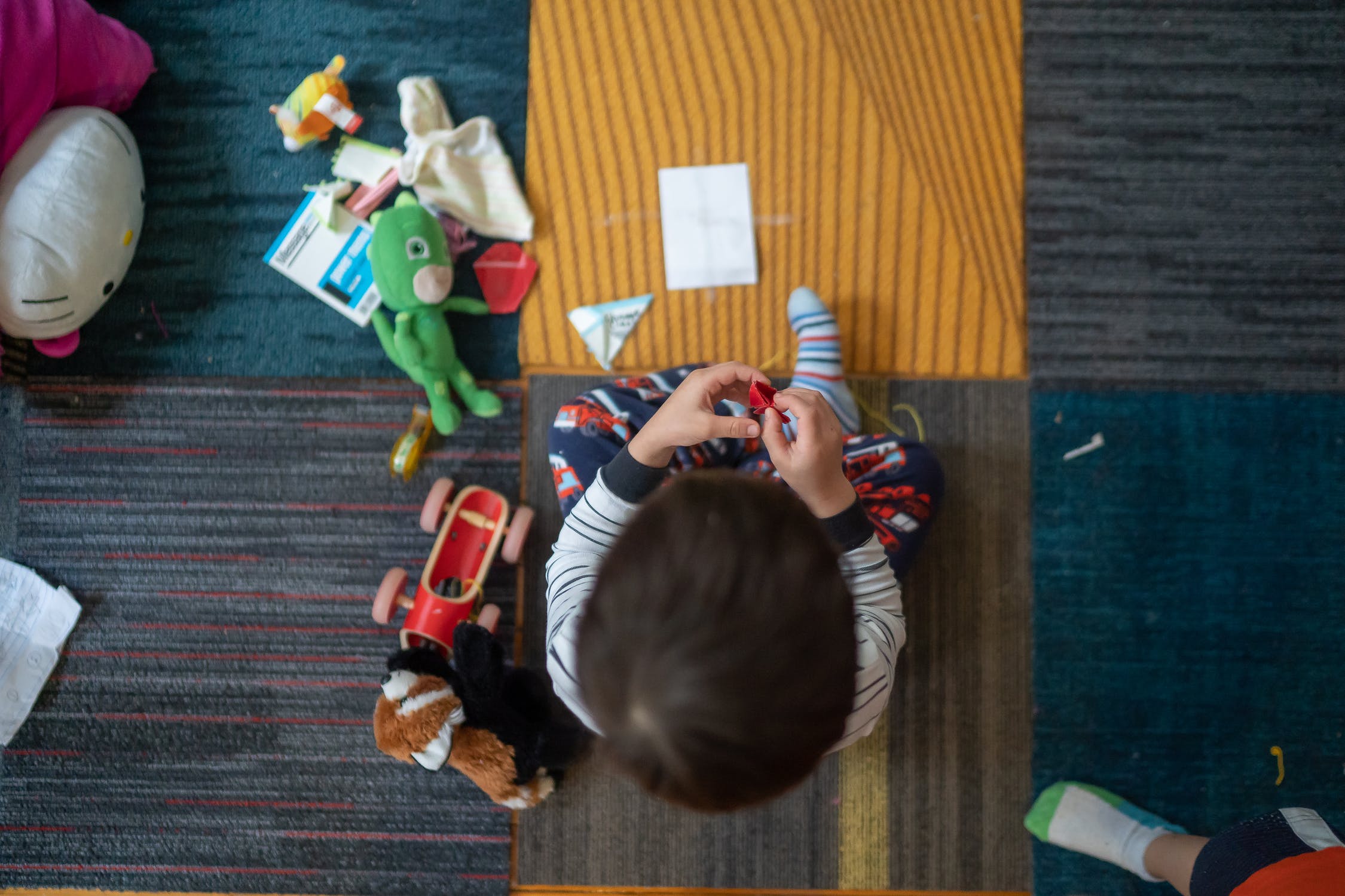 young child playing with toys in playroom