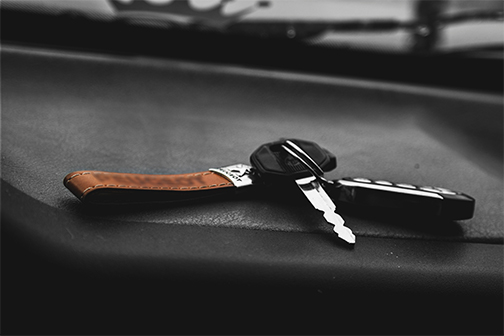 Key Ring With Leather Strap laying on a black surface.
