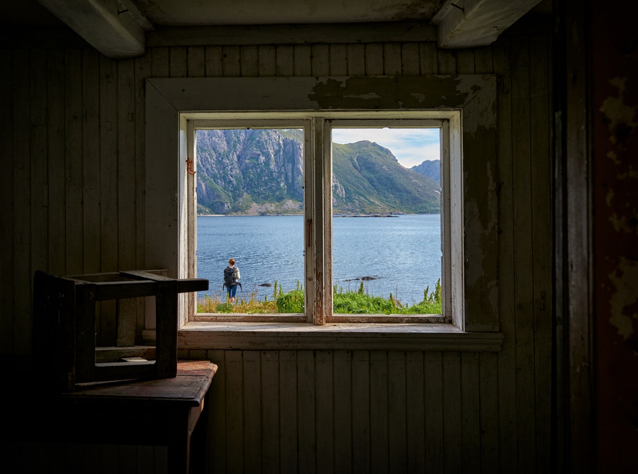 Window Looking Out at a Lake from the inside of a dark room. 