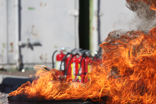 Fire in Front of Fire Extinguishers