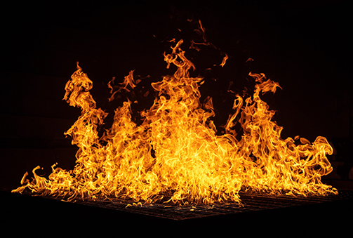 Class B Fire. Fire burning flammable gas. Black background.