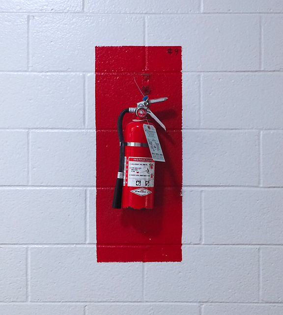 Fire Extinguisher on a White Wall