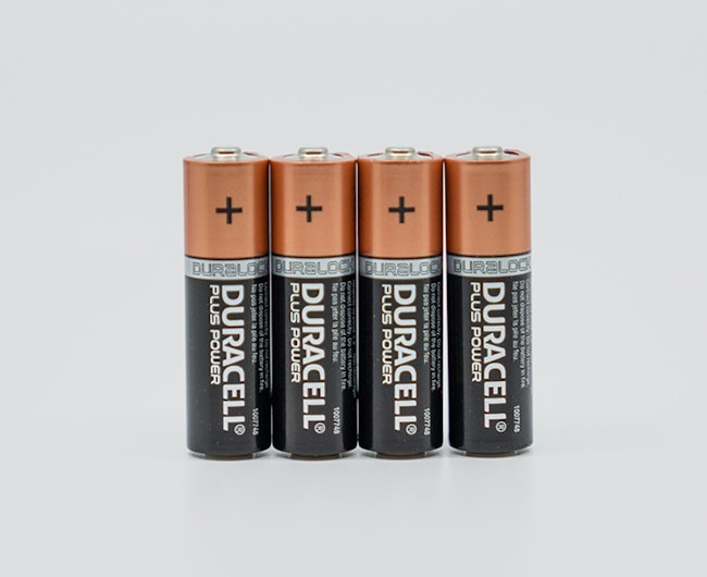four AA batteries lined up with a white background.