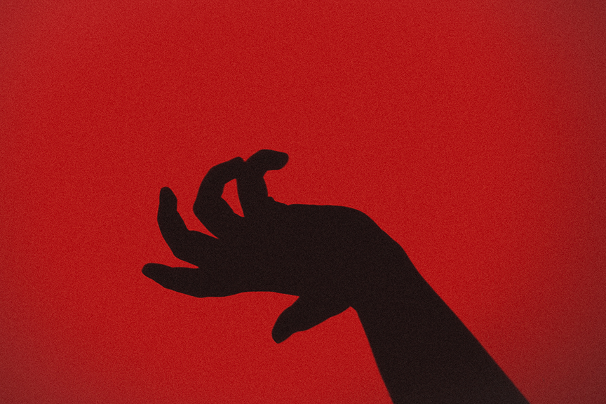 The silhouette of the hand of a beaten person held up to prevent further abuse.