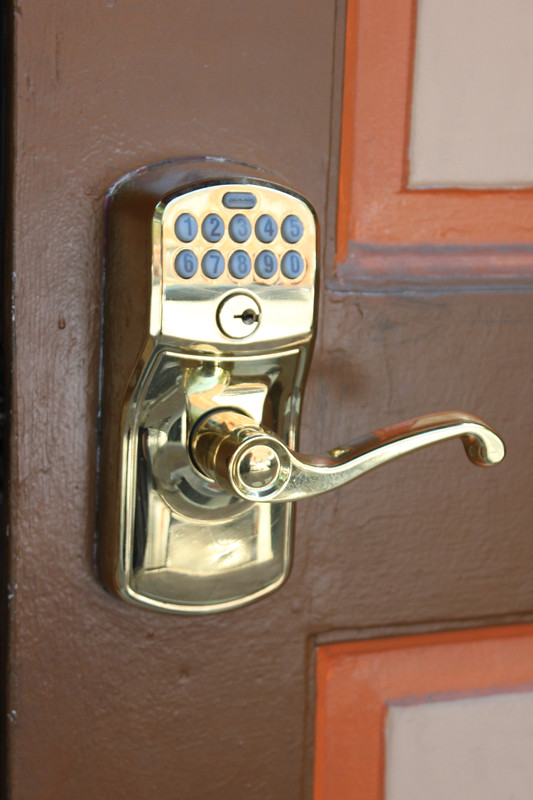 Keyless Smart Lock with a numbers keypad above the gold handle.