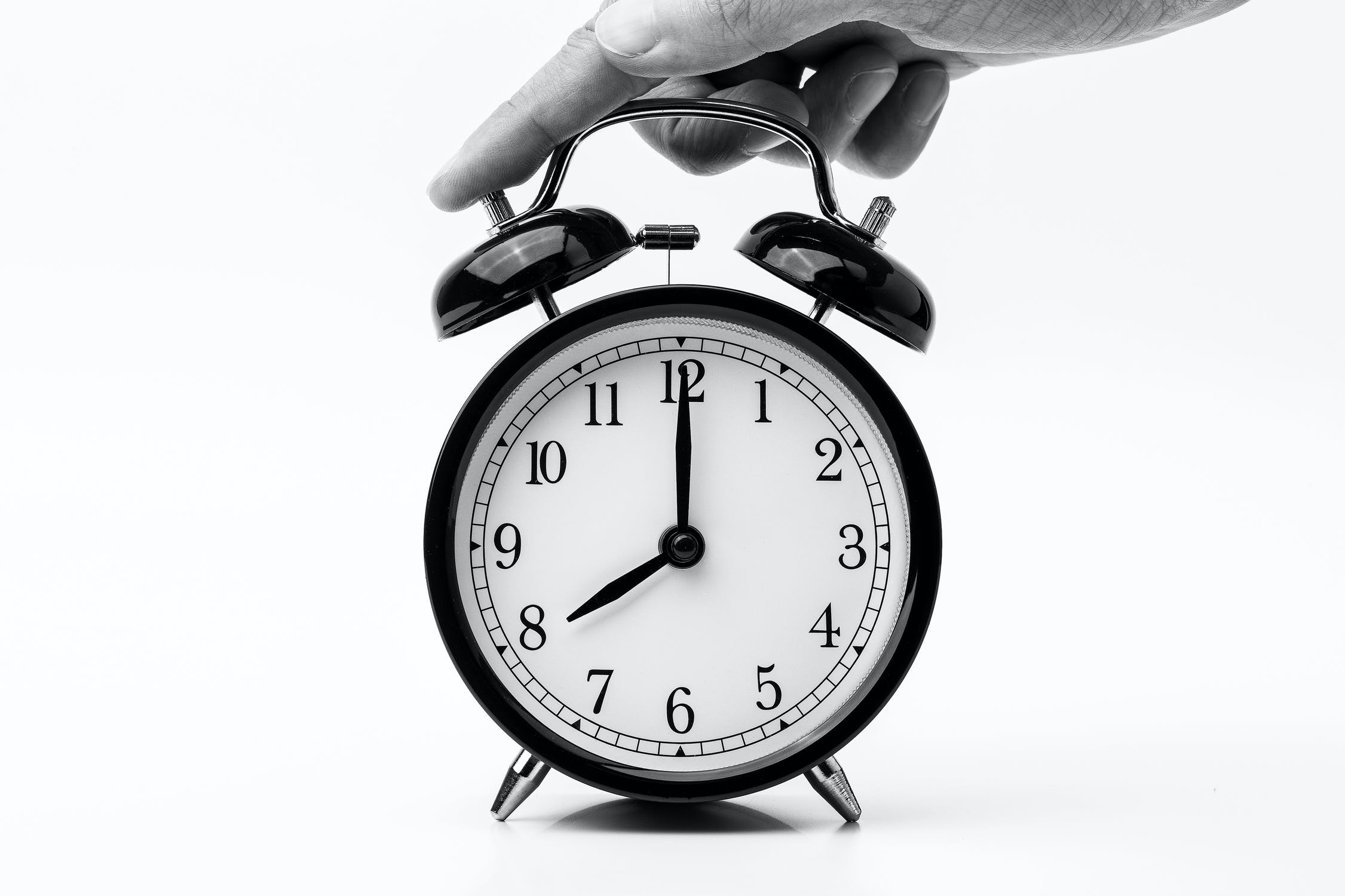 Analog alarm clock in black and white.