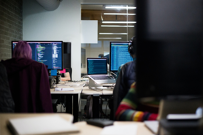 Two business employees at work at their computer stations.