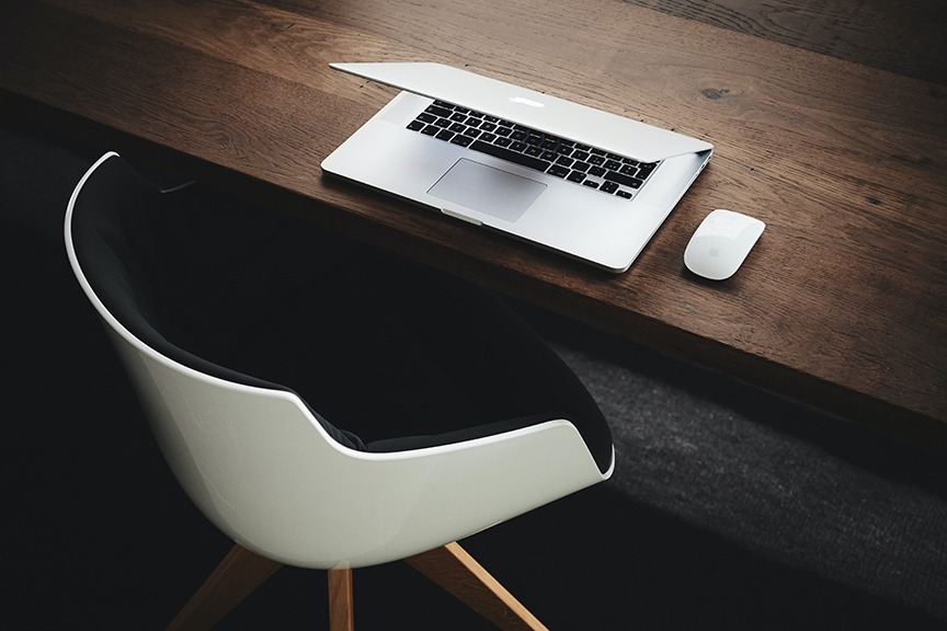 Chair, Laptop, and Table where a person would do business work.