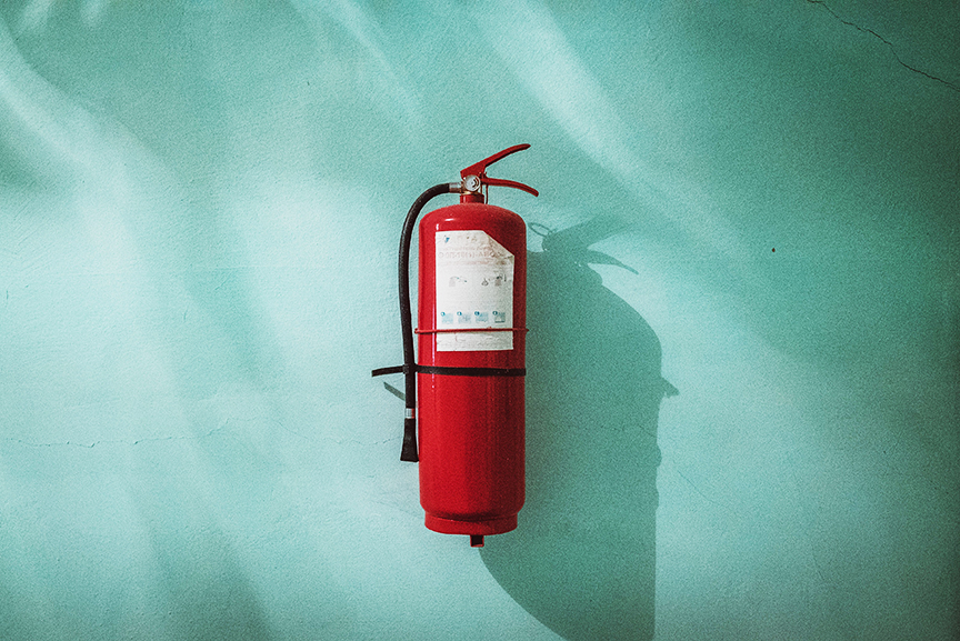 Fire Extinguisher mounted on the wall and ready to be used.