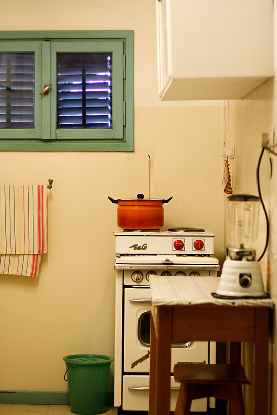 Interior shutters covering a small window in a quaint kitchen.