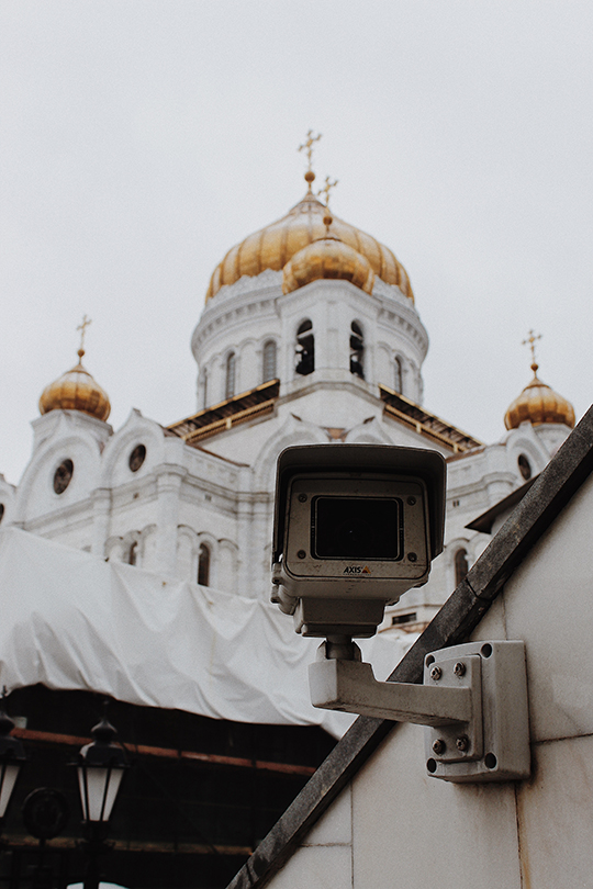 Surveillance camera in front of a cathedral.