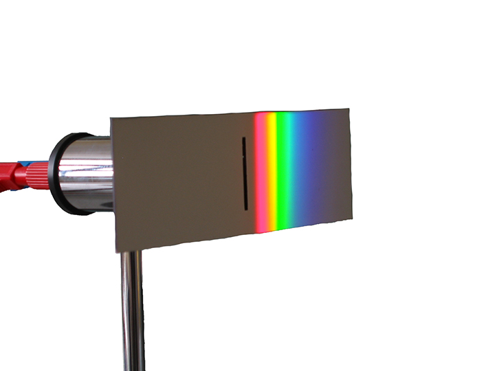 Infrared detector. A metal plate with a rainbow of light across it.