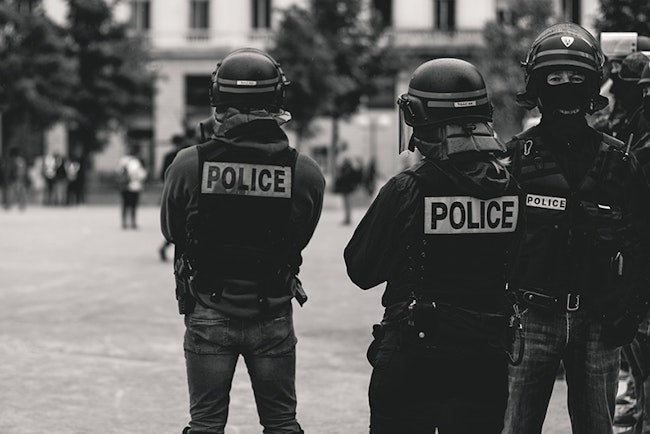 Policeman in riot armor responding to an alarm