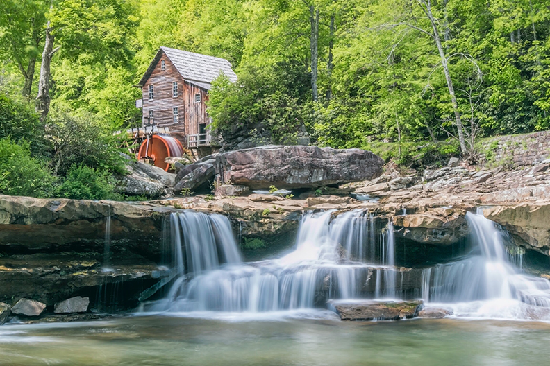 Mill on a forested river in West Virginia.
