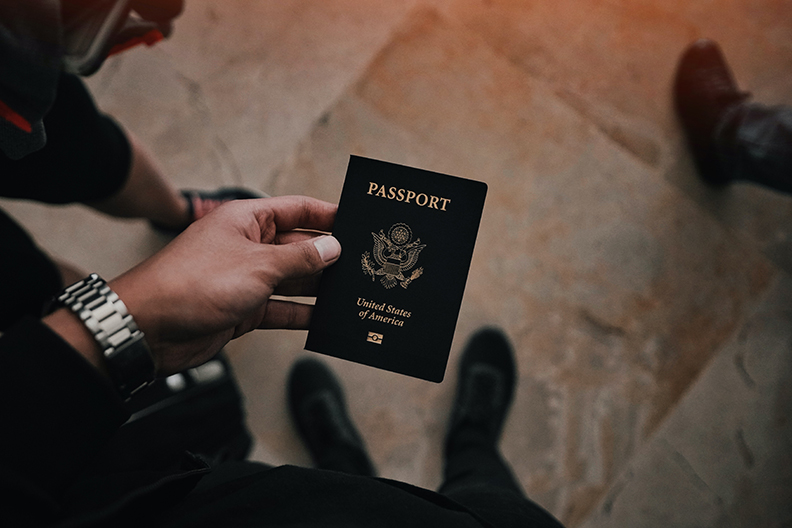 Man holding a passport to be stored in a personal safe. 