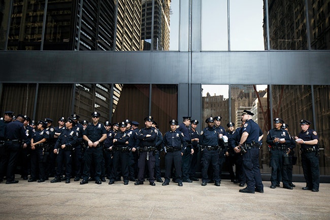A Bunch of New York Police Officers Line Up Against A Building Ready to Help Lower the Crime Rate