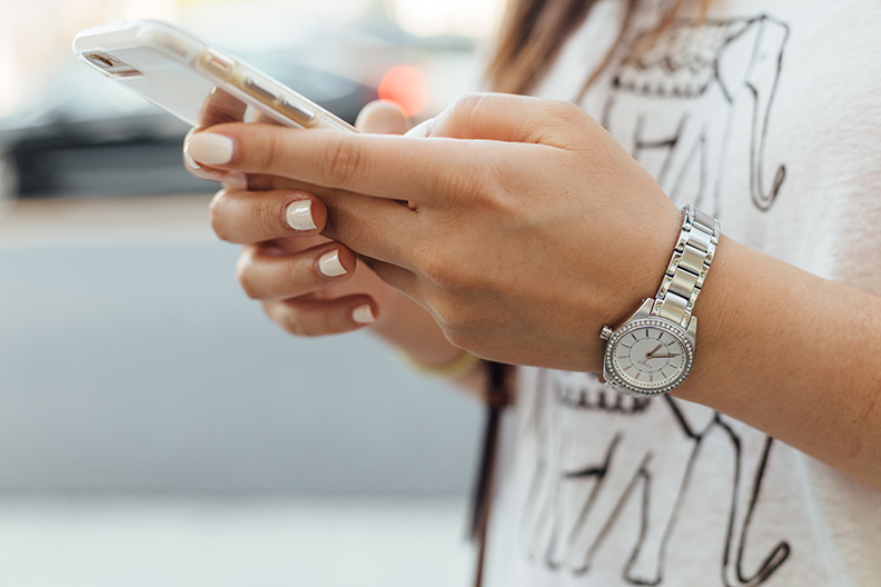Woman on her cell phone being asked for her personal information by an identity thief