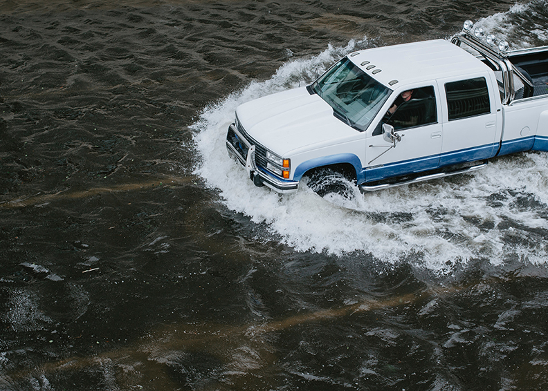 Truck driving through a foot of flood water