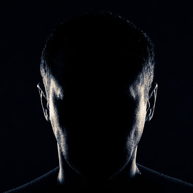 Silhouette of a burglar's face. All facial features are in darkness
