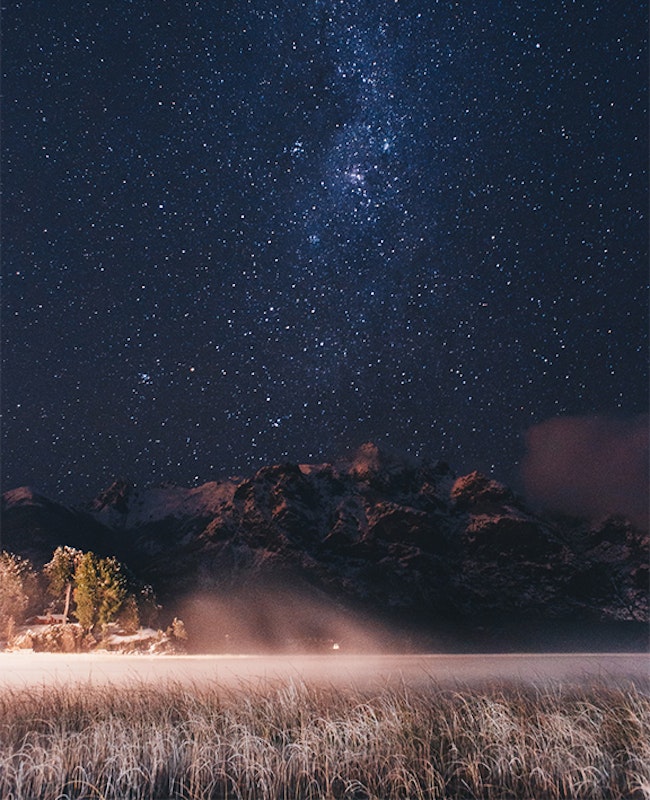 Field and stars at night.