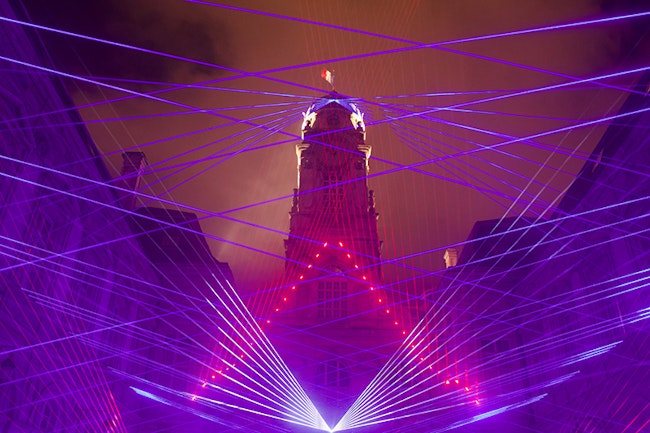 A Wall of laser lights outside in the city.