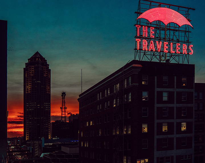 "The Travelers" sign with the 801 Grand building in the background just as night falls.