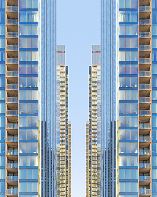 Apartment skyscrapers. There are glass windows that see into each apartment.