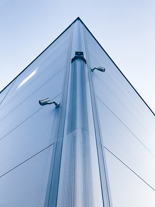 Two cameras of an 8 camera security system mounted at the corner of a building