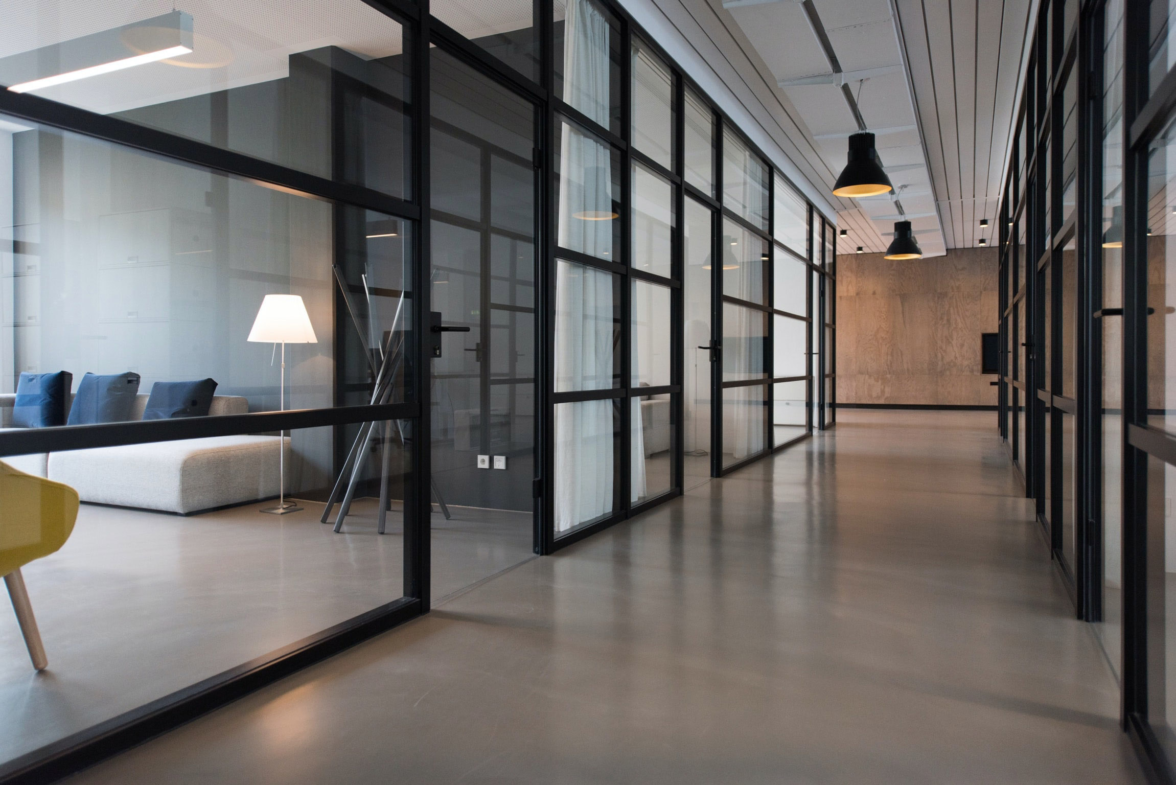A clean modern looking business hallway with partial view of an office space