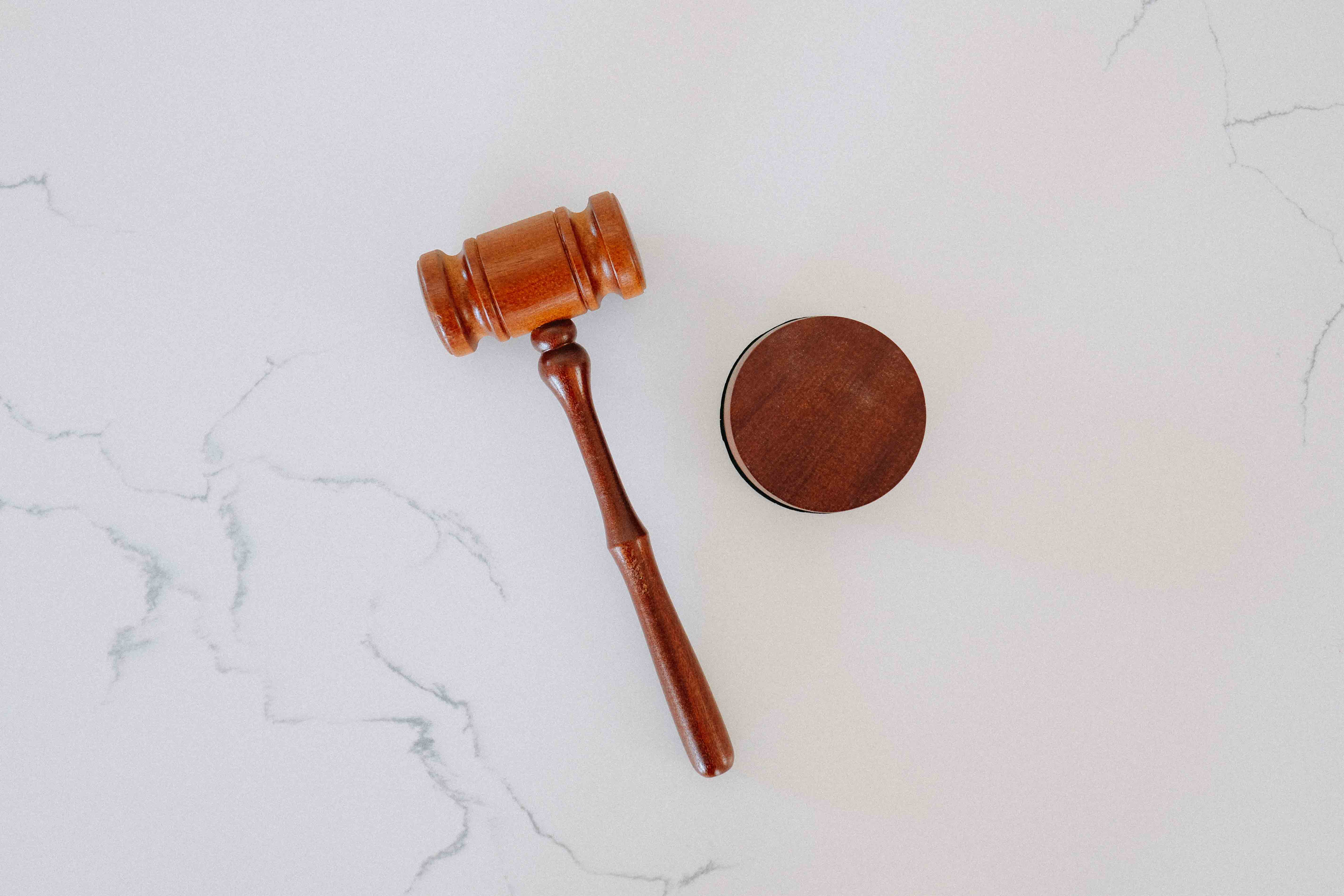 A wooden judicial gavel and sounding block