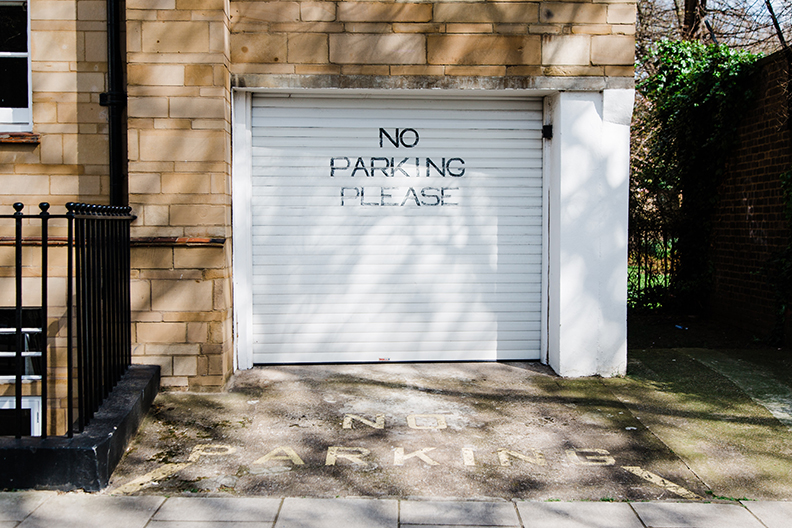 No Parking Painted onto Garage and short Driveway. driveway alarm would be perfect for being alerted to someone parking here.
