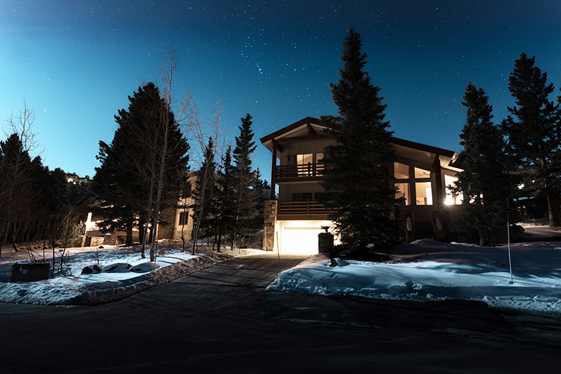 Log Home and Driveway at Night in winter.
