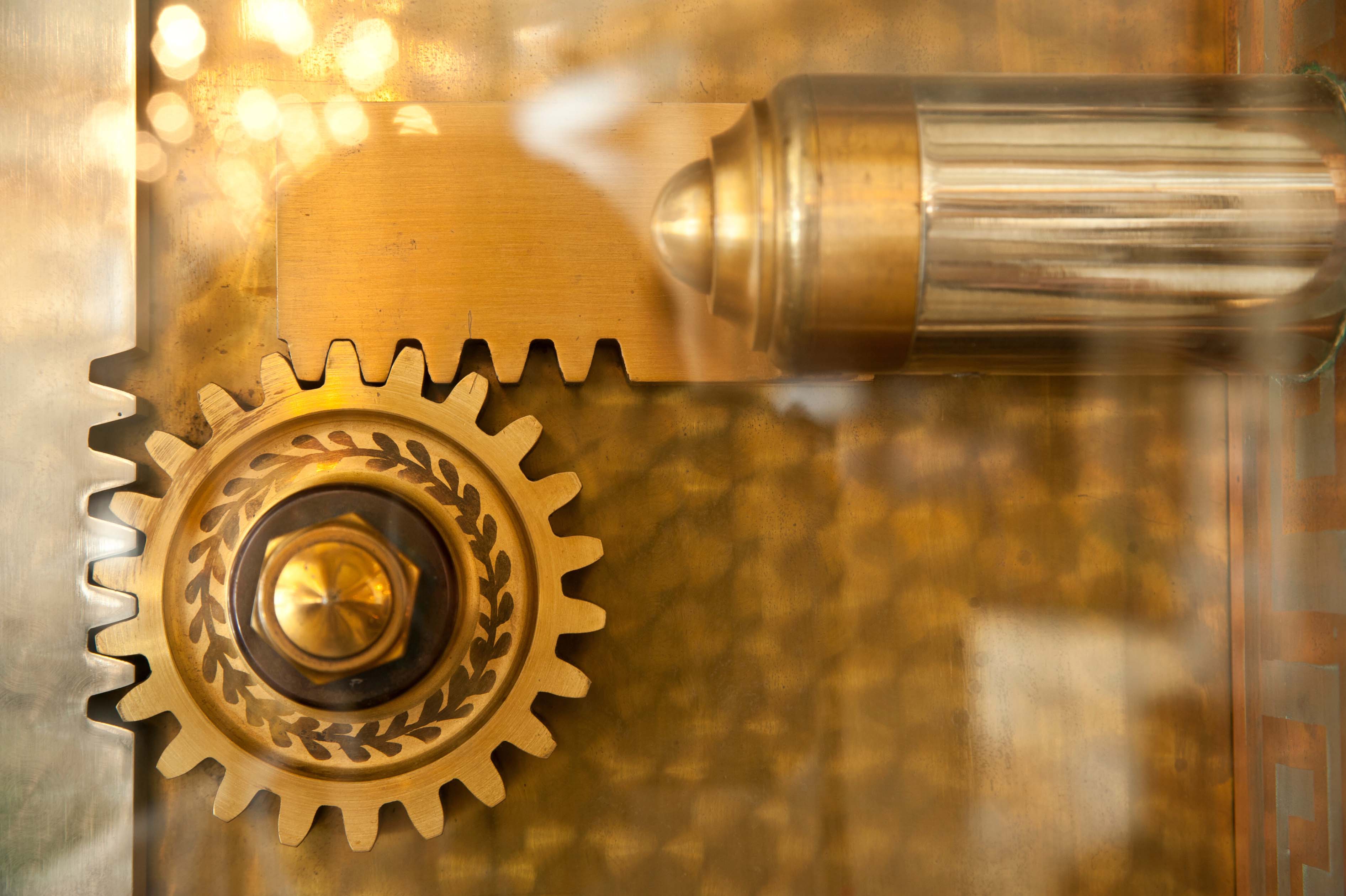A golden decorative set of gears that are part of a locking mechanism