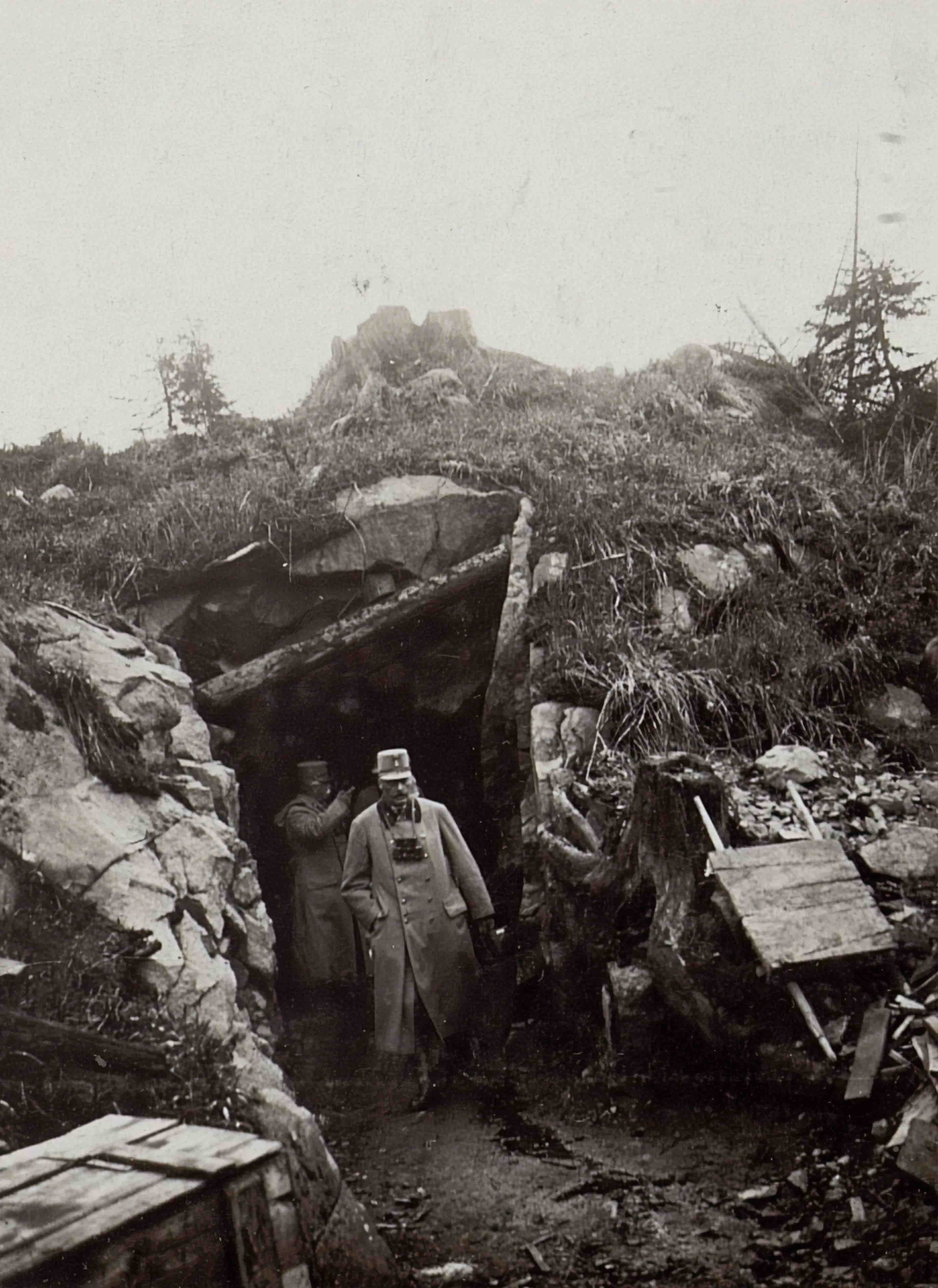 Two soldiers coming out of a tunnel with crates and debris around them