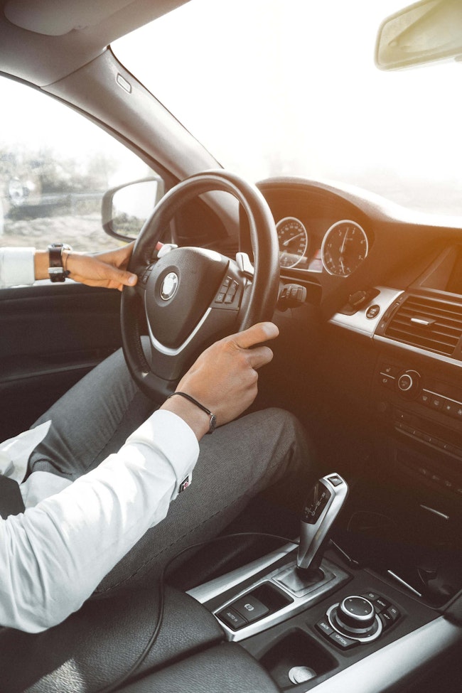 A man holding the steering wheel.
