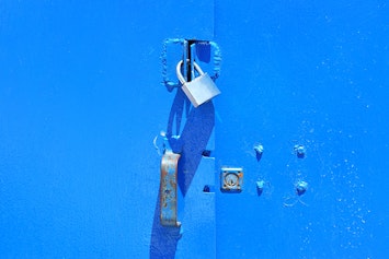 Blue shed locked with a padlock.