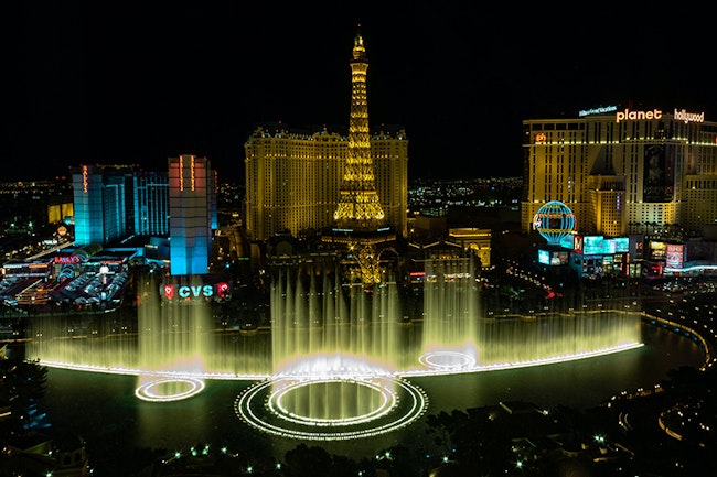 Downtown Las Vegas at Night. The Eiffel tower replica and fountain can be seen in the photo.