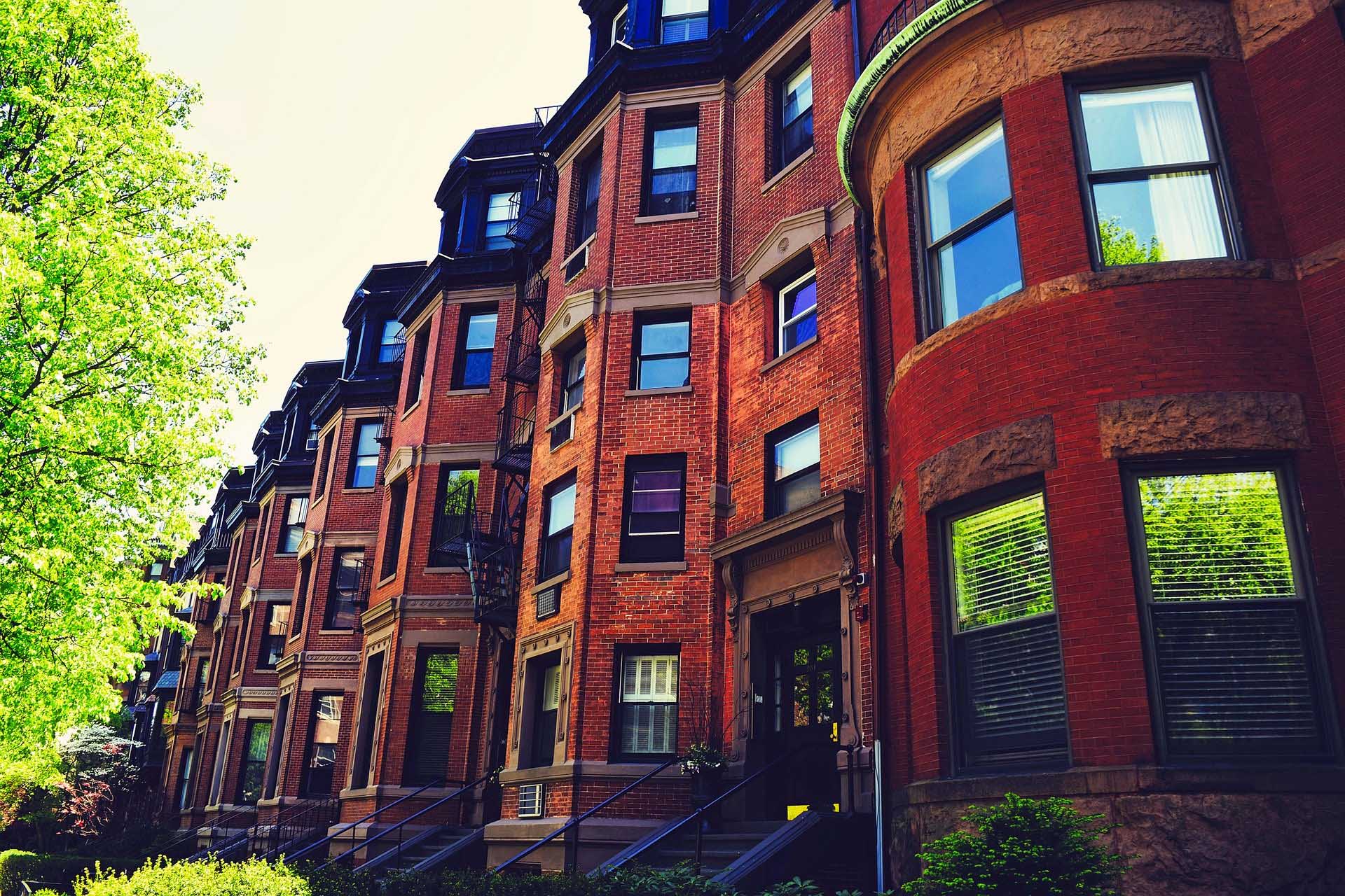 Brick buildings with green trees and reflective windows