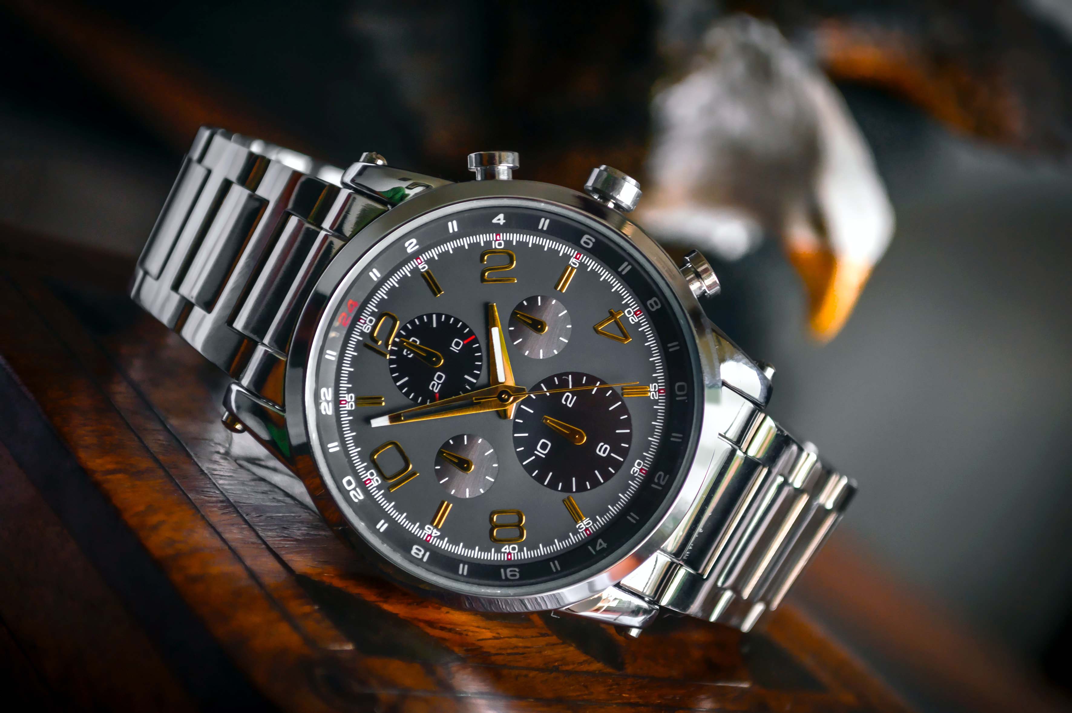 A luxury watch on a wooden desk