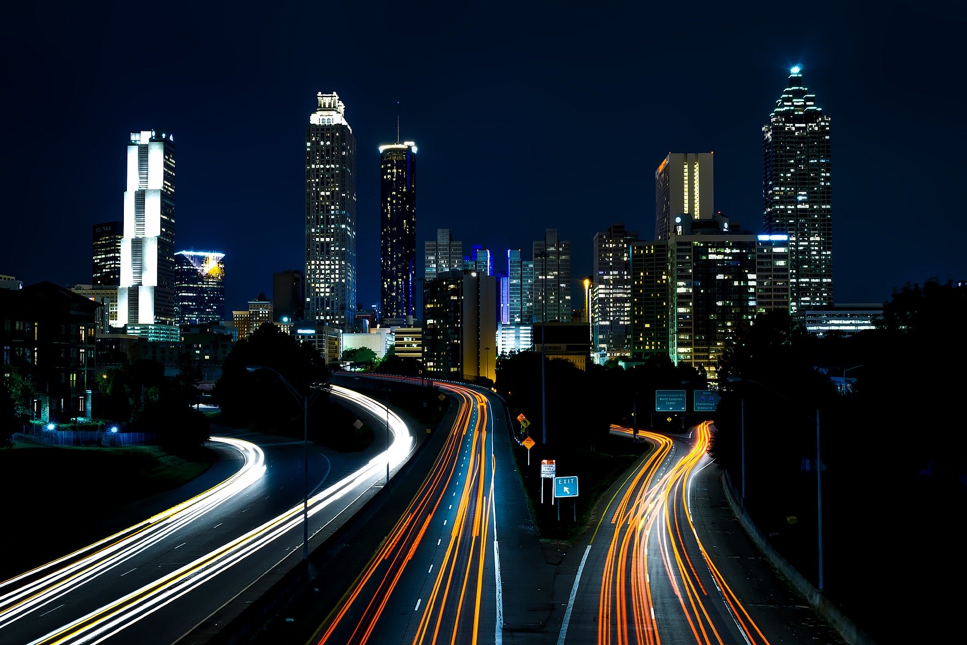 Atlanta at night with bright buildings and streams of light on the streets
