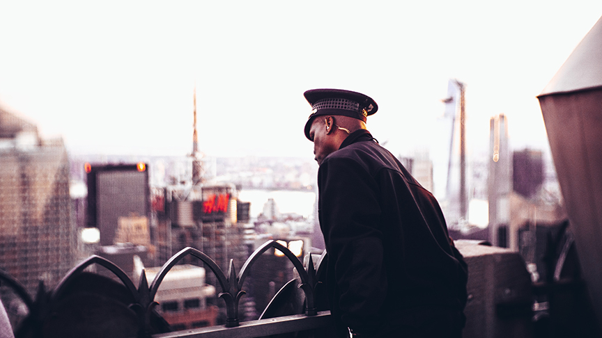 One of the personal security guards with earpiece on top of a New York building