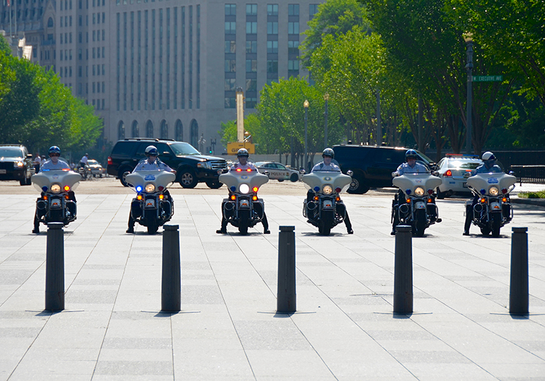 Cops and secret service guardian presidential motorcade.
