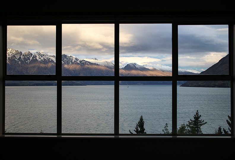 Window Camera View of Lake and Snow-Capped Mountains
