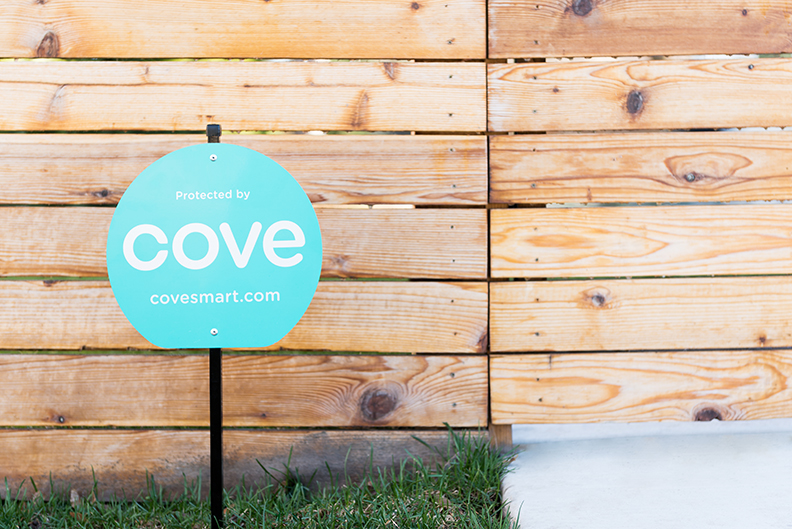 Cove Yard Sign In Front of Wooden Fence